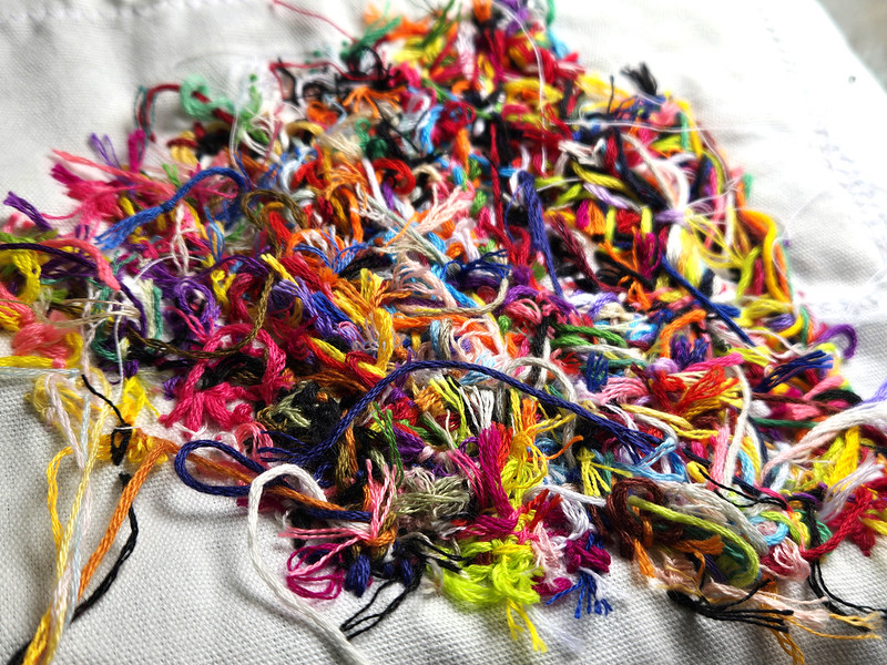 A horrible mess of embroidery thread and knots and loose ends in all colors